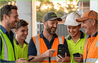 Tradies in high-vis looking at Lakki on a phone